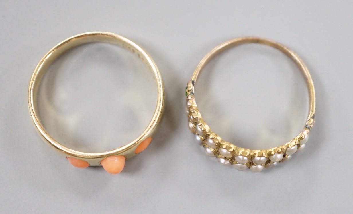 A late Victorian 15ct gold and three stone split coral set ring, size O, gross 3.3 grams and a similar yellow meta seed pearl and garnet set half hoop ring, size N, gross 1.4 grams.